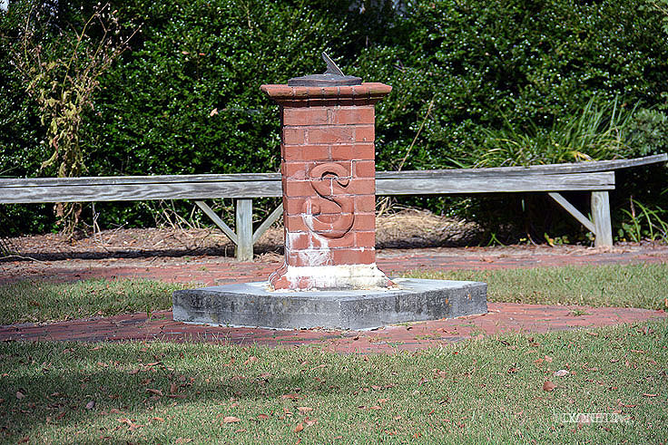 A sun dial stand displays an 