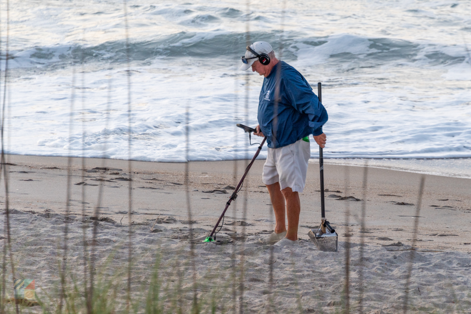 A man metal detecting on the beach